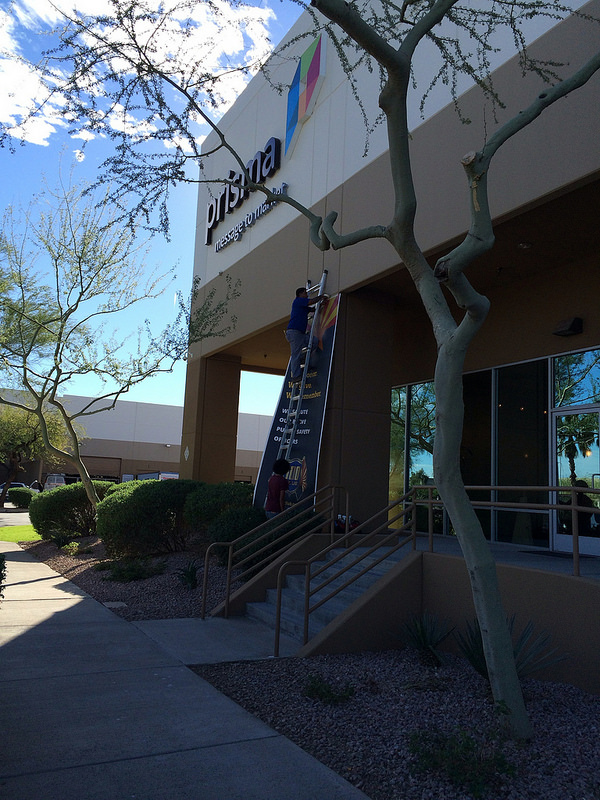 A banner to honor John Hobbs is installed outside the Prisma offices.