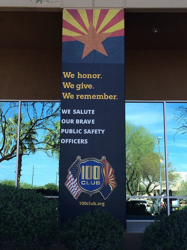 The banner will remain outside the Prisma offices while the city mourns the loss of a veteran police officer.